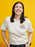 Person wearing a t-shirt with 'Arthur' characters on a yellow background