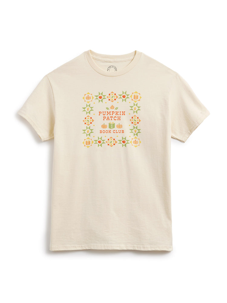 A cream-colored short-sleeve crewneck t-shirt featuring a colorful graphic on the chest that reads 'Pumpkin Patch Book Club' surrounded by a floral border.