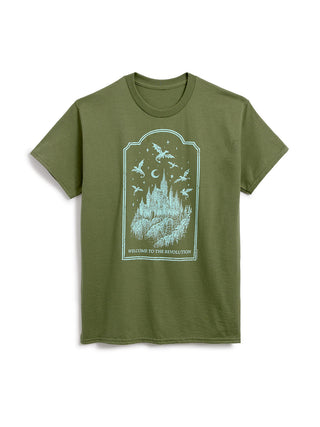 An olive green short-sleeve t-shirt with a light blue graphic print on the front depicting a castle, flying dragons, and the text 'WELCOME TO THE REVOLUTION'.