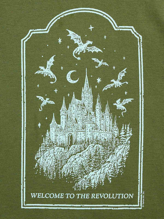 An olive green graphic print featuring a white distressed illustration of a castle, dragons, stars, and a crescent moon, with the text 'WELCOME TO THE REVOLUTION' at the bottom.