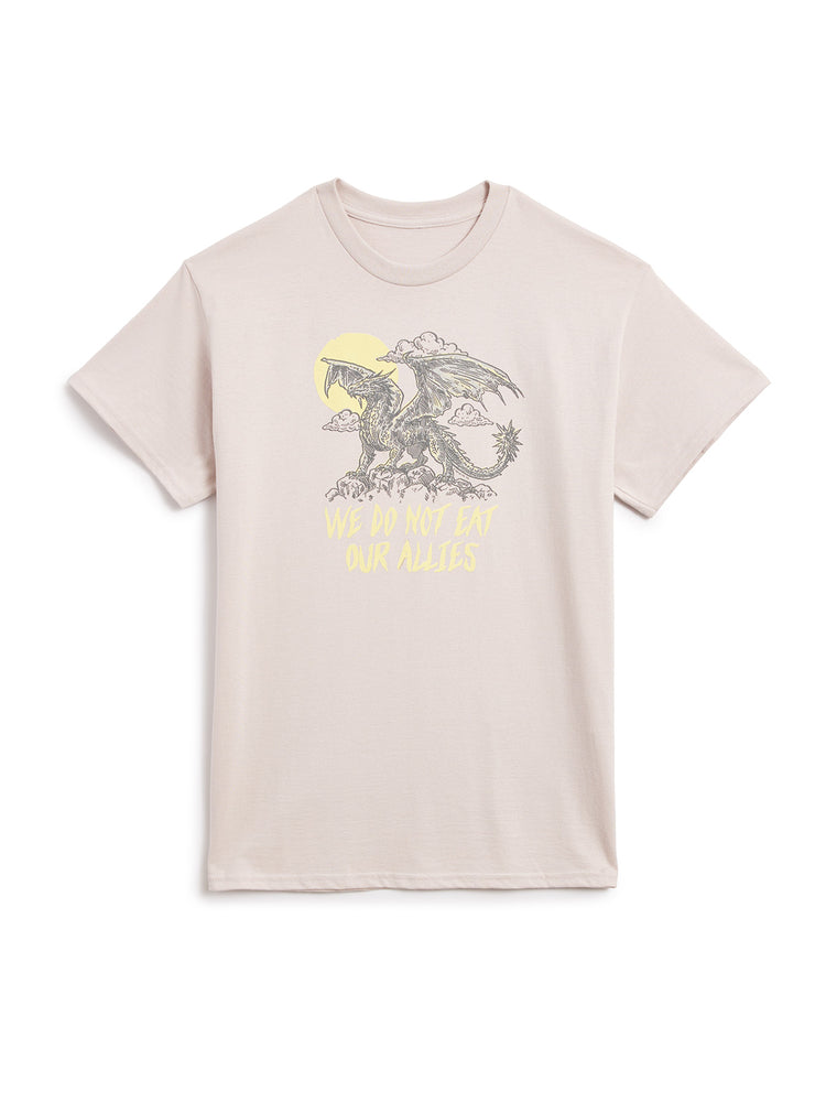 A light beige crewneck t-shirt featuring a graphic of a dragon in front of a yellow sun with the text 'WE DO NOT EAT MAN RELESS' printed below, displayed on a clean white background.