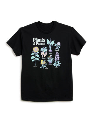 A black short-sleeve crewneck t-shirt featuring a graphic print of various illustrated plants and the text 'Plants of Panem' on the front, displayed against a plain white background.
