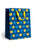 A blue gift bag with a festive pattern of yellow stars, dreidels, menorahs, and open books, featuring bright yellow handles, set against a plain white background.