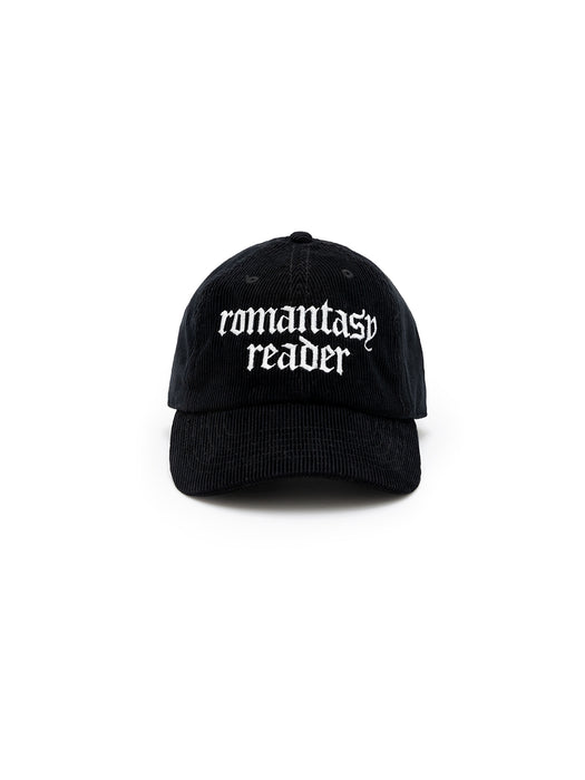 A black corduroy baseball cap with 'romantasy reader' embroidered in white text on the front.