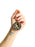 Hand holding a keychain with a design and text on a white background