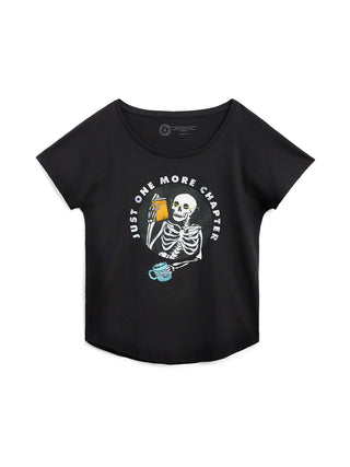 Black t-shirt with skeleton graphic and 'Just One More Chapter' text on a white background