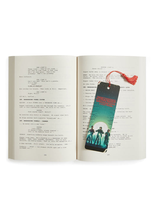 Open book with a bookmark featuring a group of people on a scenic background