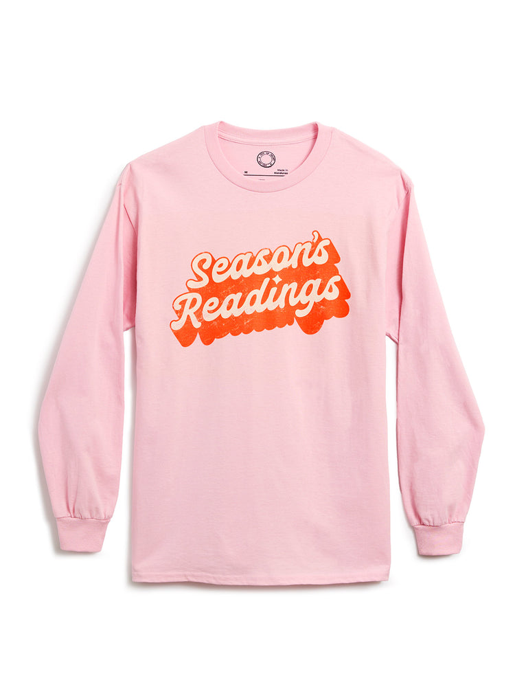 A light pink long-sleeve shirt with a retro-style graphic reading 'Season's Readings' across the chest, displayed on a clean white background.
