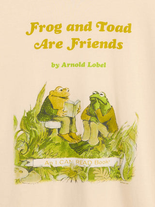 A cream-colored book cover for 'Frog and Toad Are Friends' by Arnold Lobel, featuring a colorful illustration of two frogs sitting together in grass and reading a book.