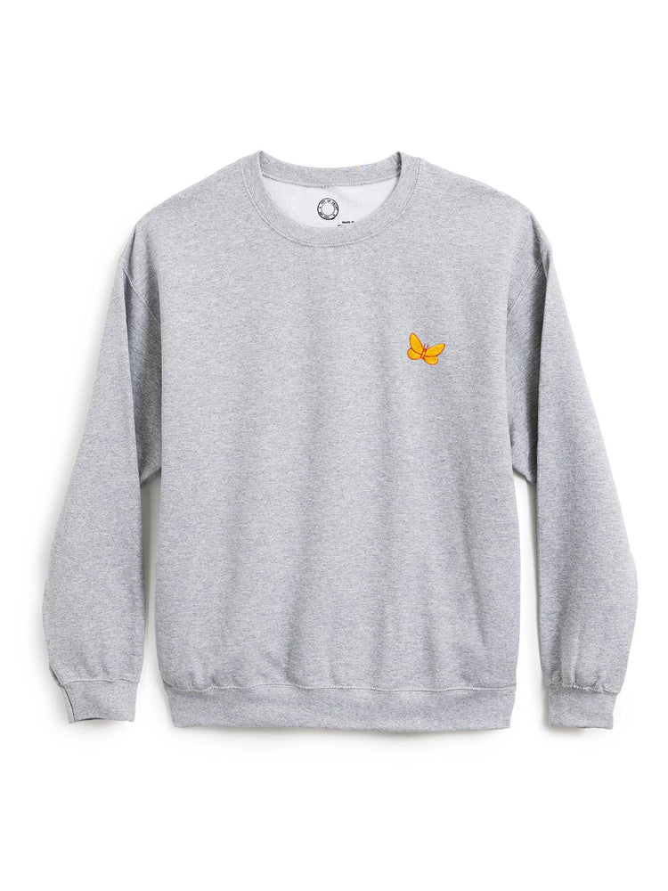 A light gray heather crewneck sweatshirt with a small yellow butterfly graphic on the left chest, displayed on a clean white background.