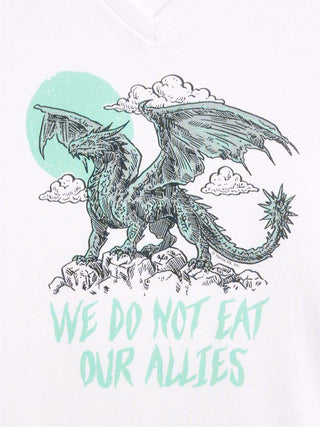 A white V-neck t-shirt featuring a graphic print of a detailed black and mint green dragon standing on rocks with clouds and a mint green sun, above the text 'WE DO NOT EAT OUR ALLIES' in a matching mint green font.