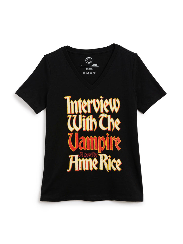 A black short-sleeve v-neck t-shirt featuring a stylized graphic print on the front that reads 'Interview With The Vampire' in a gothic font, with 'A Novel by Anne Rice' printed below in red.