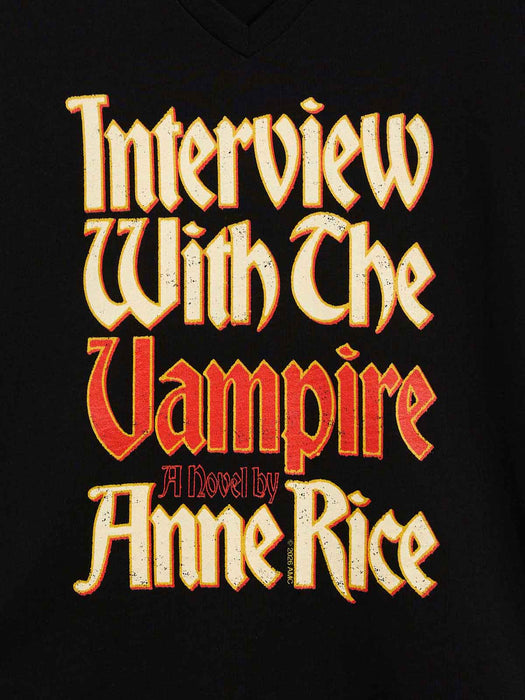 A close-up of a black v-neck t-shirt featuring a large, stylized graphic print of the book cover for 'Interview With The Vampire A Novel by Anne Rice' in a distressed gothic font.