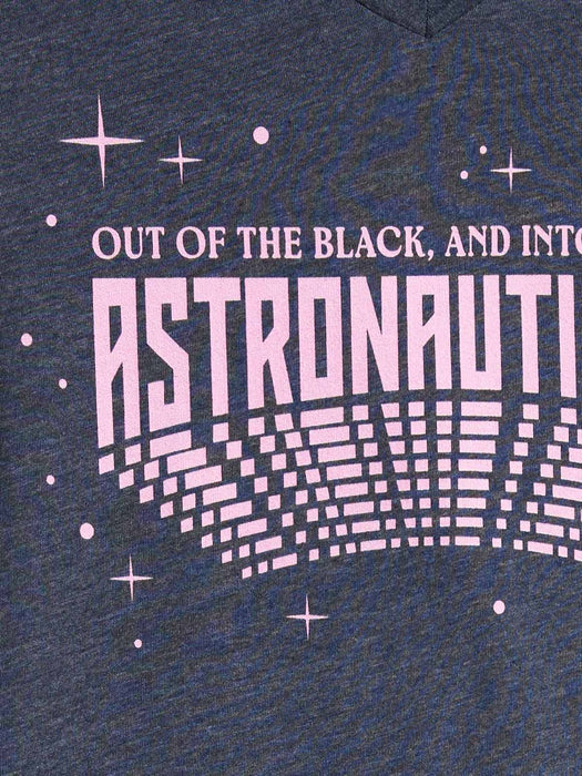 Close-up of a heather navy blue graphic print on a t-shirt. The design features the text 'OUT OF THE BLACK, AND INTO ASTRONAUTY' in light pink.