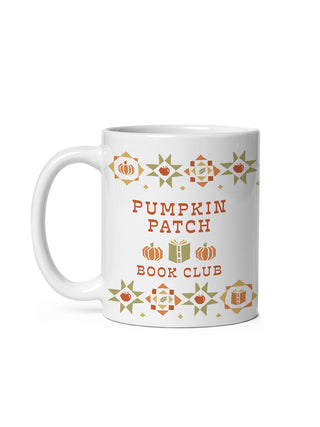 A white ceramic mug with a 'Pumpkin Patch Book Club' design featuring orange and green autumn-themed illustrations on a clean white background.