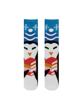 A pair of cozy socks with a penguin design holding a stack of books, surrounded by snowflake patterns on a blue background.