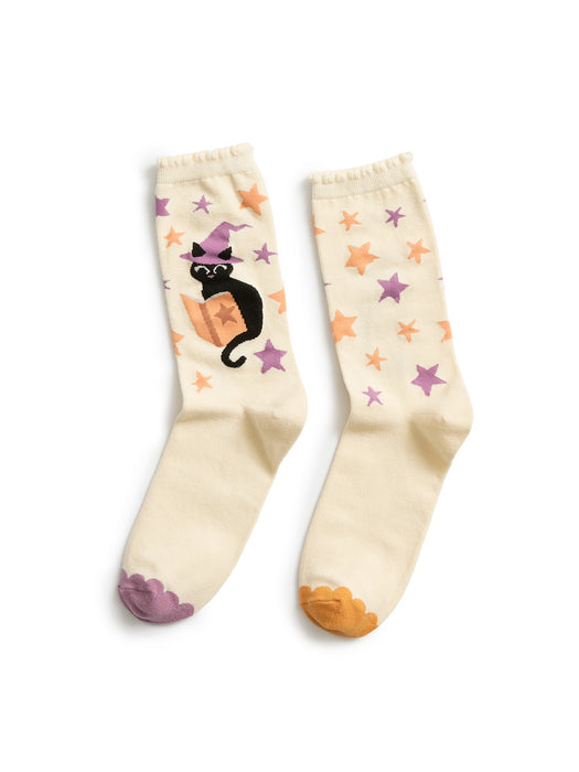 Pair of socks with a black cat in a witch hat and star patterns on a white background