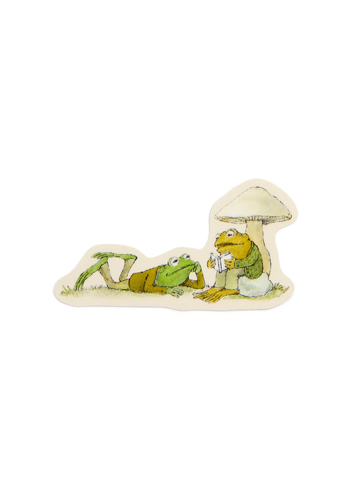 Frog laying on the ground listening to Toad reading a book under a mushroom