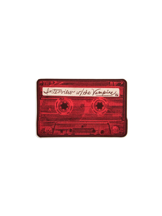 A red cassette tape sticker featuring the text 'Interview w/ the Vampire' on the label, shown on a plain white background.