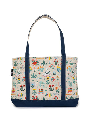 A large zippered tote bag with navy blue strap and bottom, featuring a floral and animal pattern on a beige background.