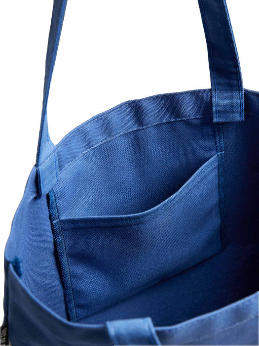 Blue tote bag with a pocket on a white background