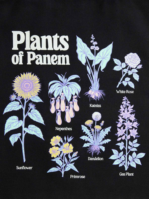 A black graphic print featuring illustrated plants with the title 'Plants of Panem' at the top. The designs include a yellow and purple sunflower, pale blue katniss, white rose, nepenthes, dandelion, gas plant, and primrose, each labeled with its name.