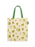 A canvas tote bag with a light beige background printed with a pattern of green frogs, white flowers, and small yellow dots, featuring green shoulder straps.