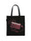 A black canvas tote bag with black shoulder straps, featuring a graphic print of a cassette tape with a rosary chain and cross in a dusty pink color, set against a plain white background.