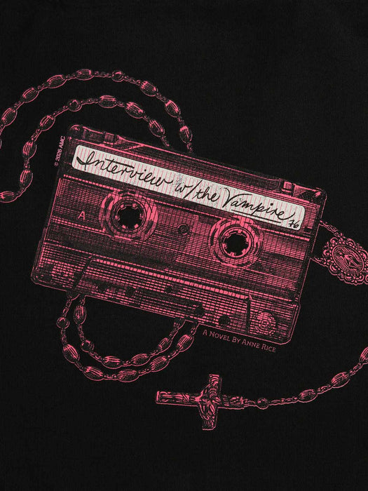A close-up of a black garment featuring a red graphic print of a cassette tape with a rosary chain and cross, with the text 'Interview with the Vampire' and 'A Novel by Anne Rice'.