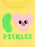 Close-up of a yellow t-shirt featuring a pink heart with a smiling face, a green pickle graphic, and the word 'PICKLES' in green letters.