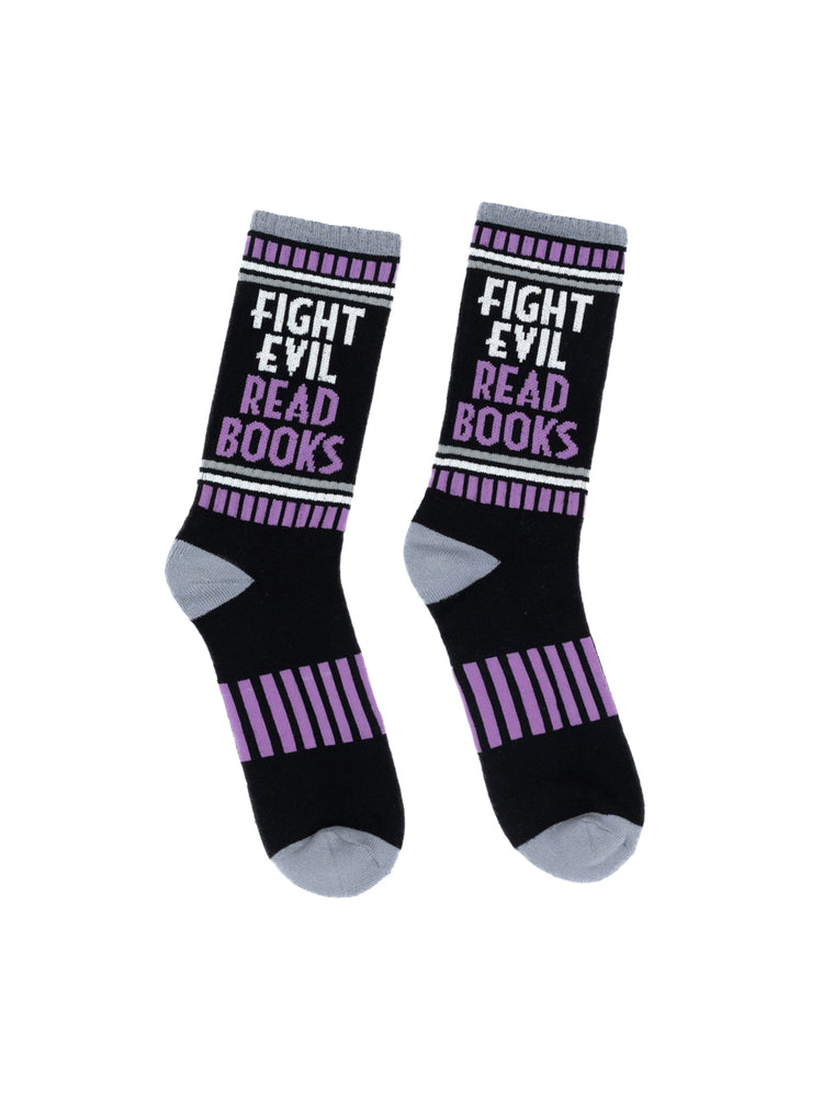 A pair of black athletic socks with the text 'FIGHT EVIL, READ BOOKS' written in white. The socks have purple stripes on the side.