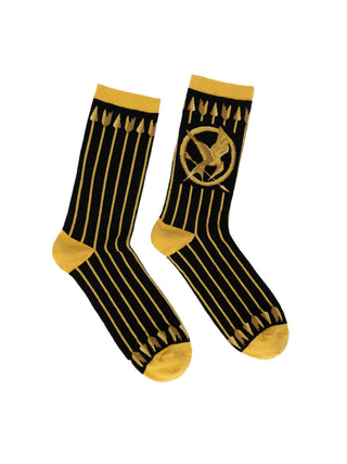 A pair of black and gold Hunger Games-themed socks featuring the Mockingjay symbol.